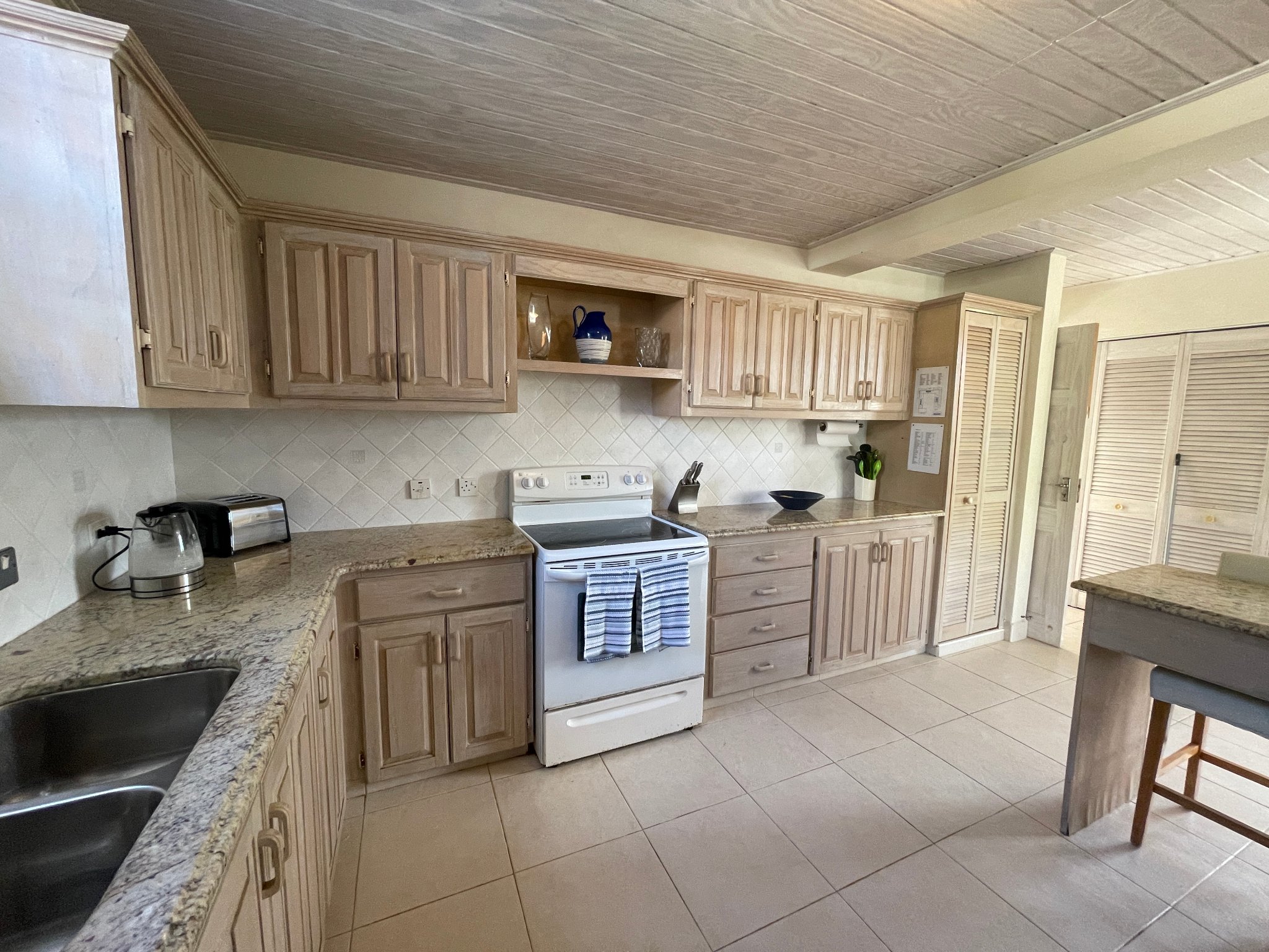 Holland Park Villa kitchen with wooden cabinets and full appliances